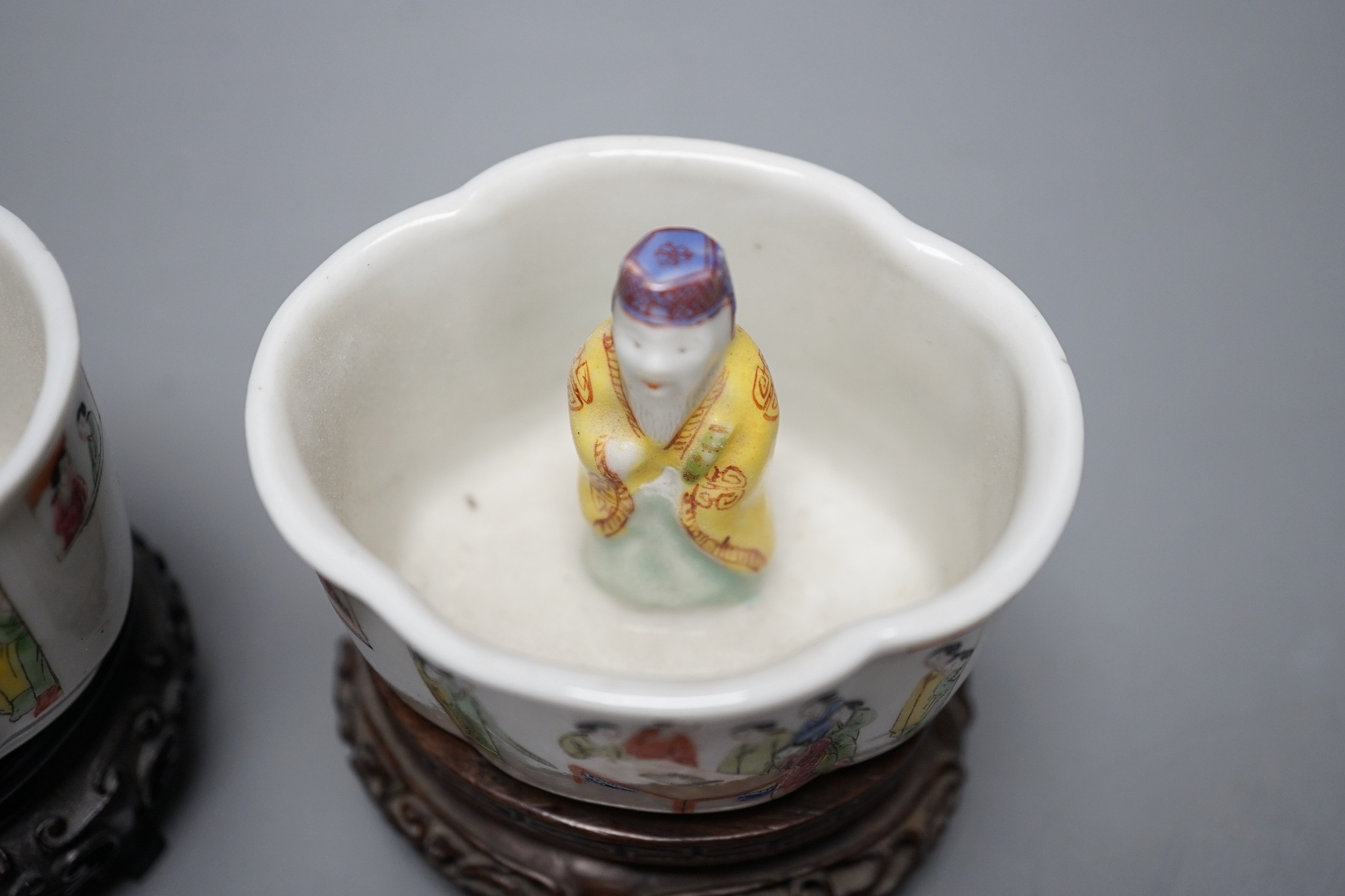 A pair of 19th century Chinese famille rose puzzle cups on stands, 8cm tall overall